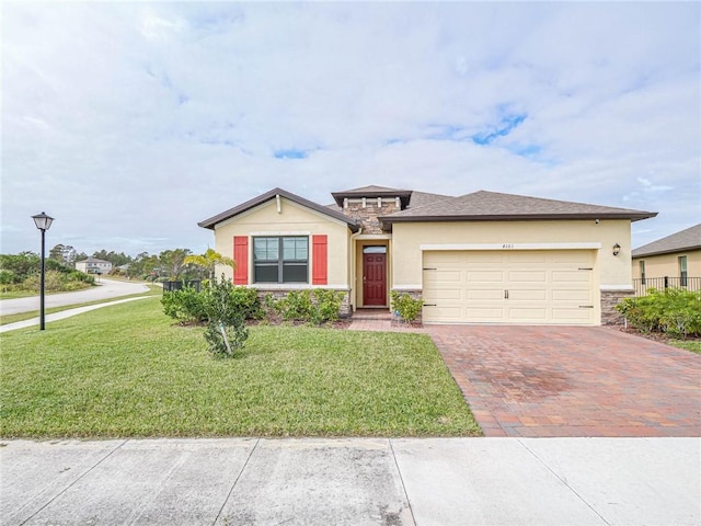 4101 Keeson Cir, Vero Beach, FL 32967 - view of front facade featuring stucco siding, stone siding, decorative driveway, and a garage