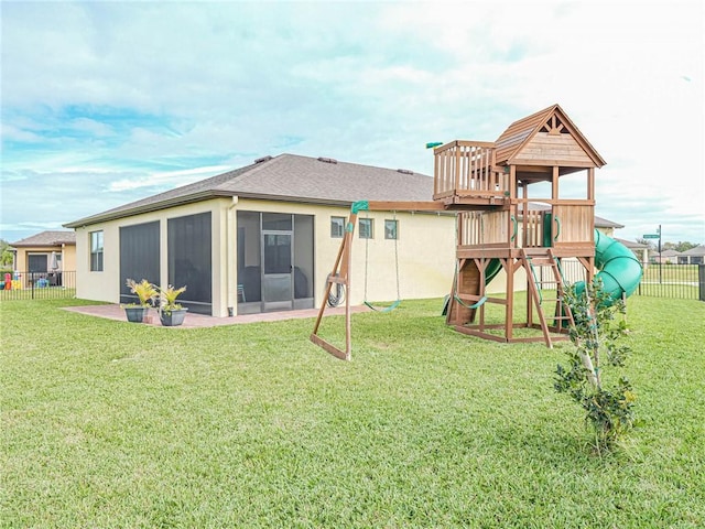 4101 Keeson Cir, Vero Beach, FL 32967 - back of house with a sunroom, a playground, and a shingled roof
