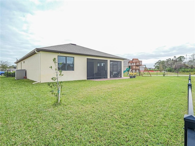 4101 Keeson Cir, Vero Beach, FL 32967 - back of house featuring a playground, stucco siding, and a sunroom