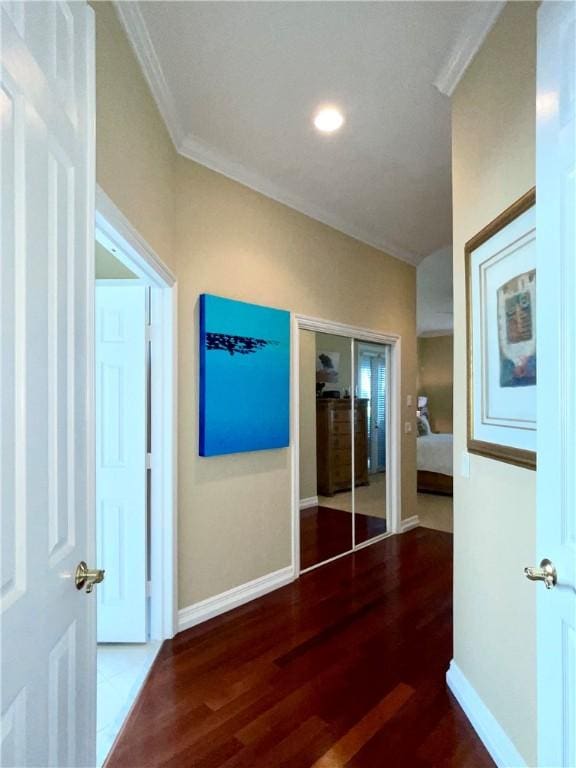 hall featuring crown molding and dark wood-type flooring