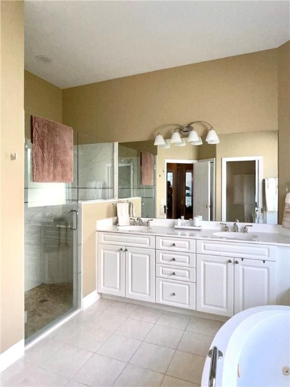 bathroom featuring tile patterned floors, vanity, and shower with separate bathtub