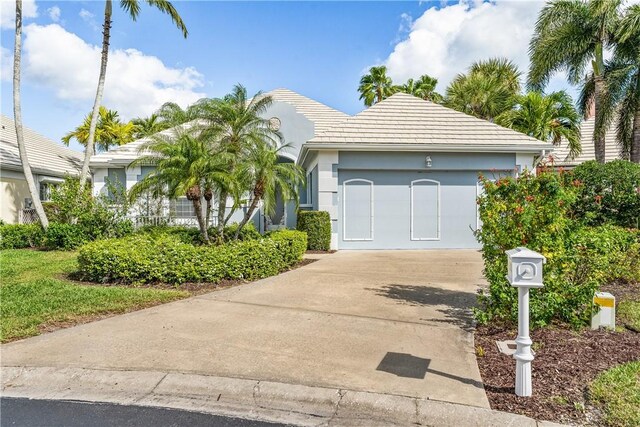 view of front of home featuring a garage and a front lawn