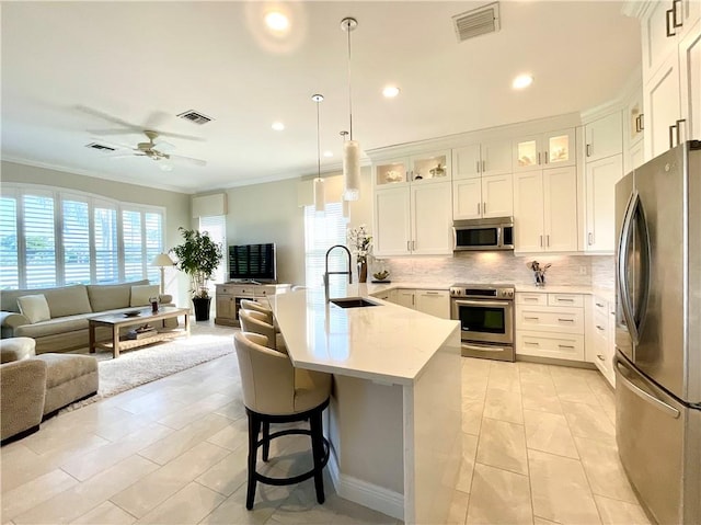 kitchen with stainless steel appliances, sink, and white cabinets