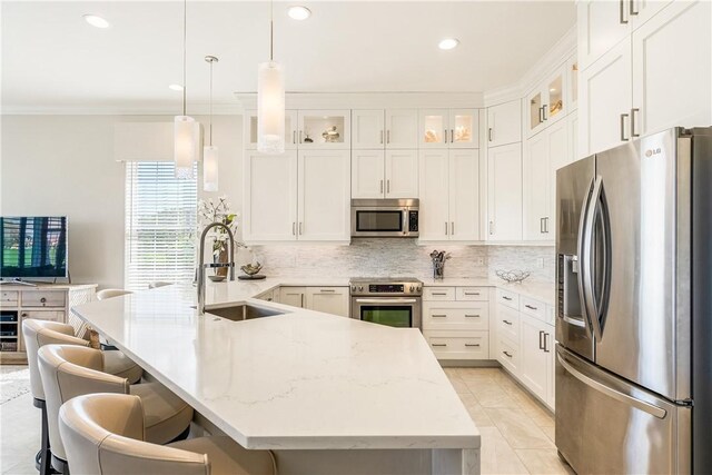 860 Saint James Ln, Vero Beach, FL 32967 - kitchen with appliances with stainless steel finishes, a sink, a peninsula, backsplash, and crown molding