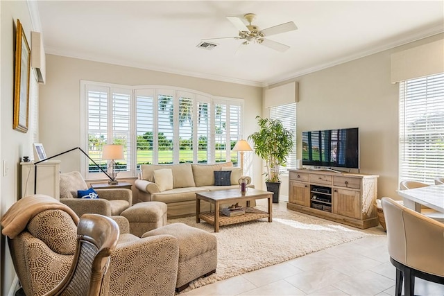 living room featuring light tile patterned floors, ornamental molding, and ceiling fan