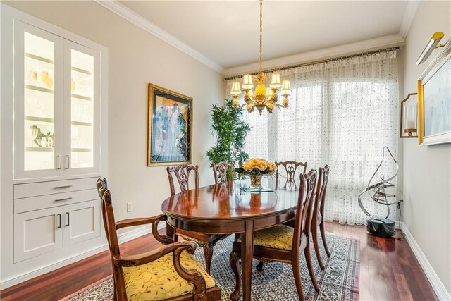 dining space featuring a notable chandelier, dark wood-type flooring, and ornamental molding