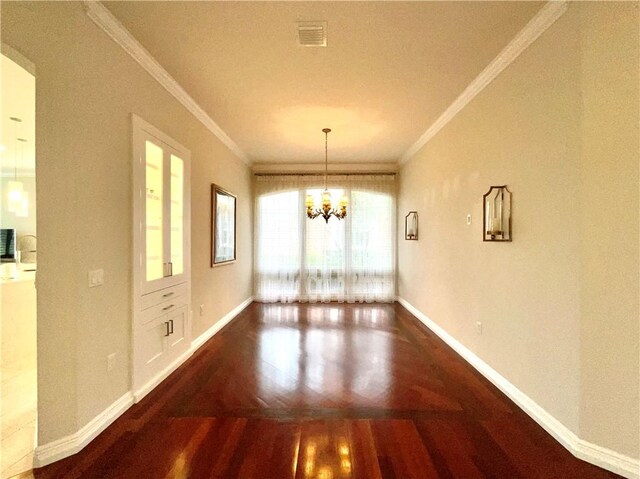 860 Saint James Ln, Vero Beach, FL 32967 - unfurnished dining area featuring ornamental molding, wood finished floors, baseboards, and a chandelier