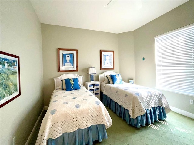 bedroom with multiple windows and carpet flooring