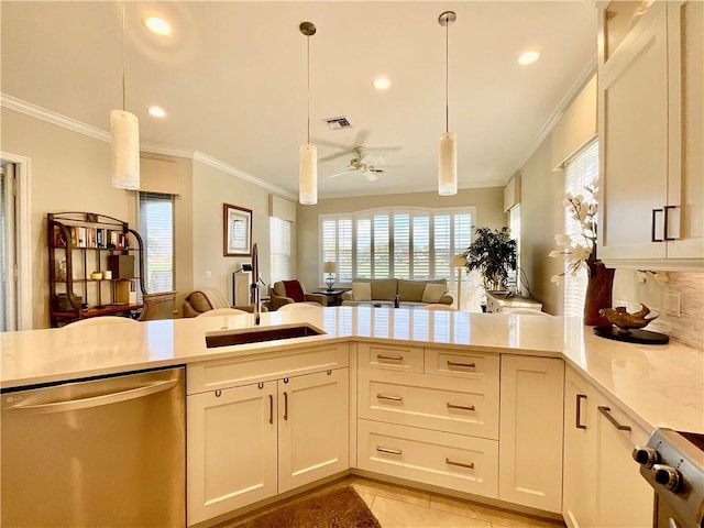 kitchen featuring sink, dishwasher, plenty of natural light, ornamental molding, and decorative light fixtures