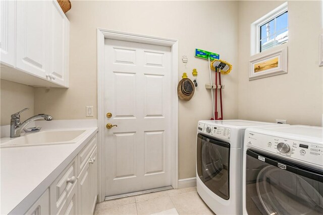 860 Saint James Ln, Vero Beach, FL 32967 - laundry room featuring cabinet space, separate washer and dryer, and light tile patterned floors