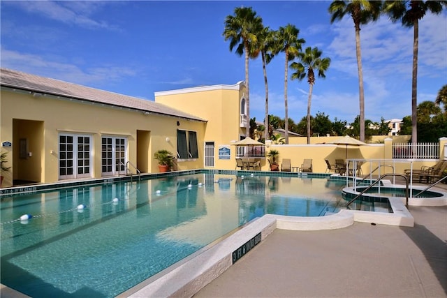 view of pool with an in ground hot tub and a patio area