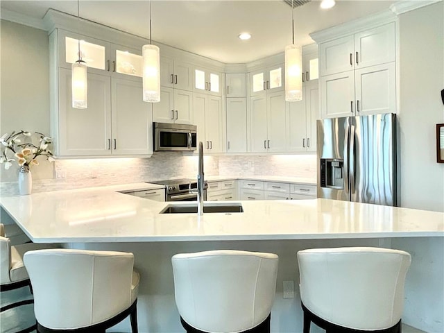 860 Saint James Ln, Vero Beach, FL 32967 - kitchen with appliances with stainless steel finishes, a peninsula, light countertops, tasteful backsplash, and recessed lighting