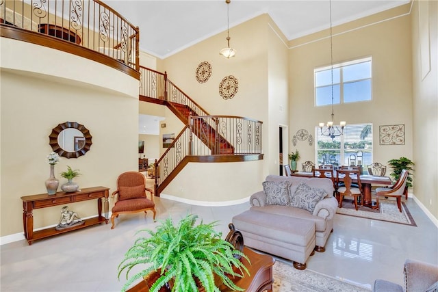 living room featuring tile patterned flooring, ornamental molding, a high ceiling, and an inviting chandelier