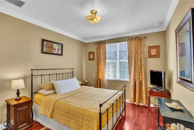 bedroom featuring dark hardwood / wood-style floors and ornamental molding