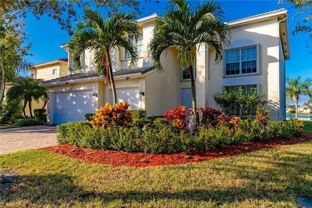 view of front of home with a front yard and a garage