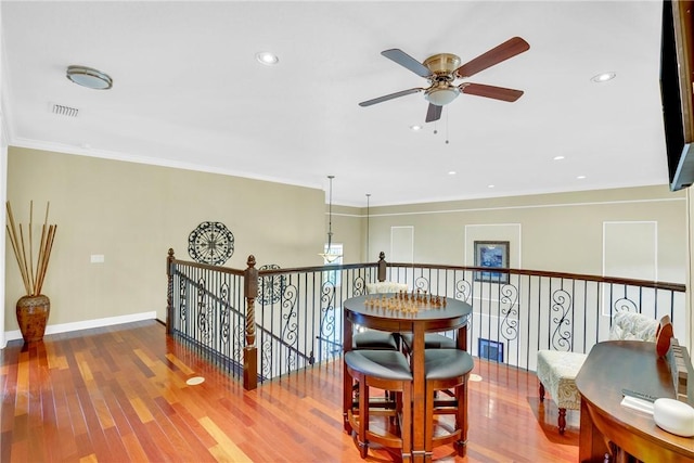 hallway with crown molding and wood-type flooring