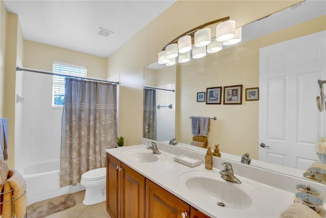 full bathroom featuring tile patterned floors, vanity, shower / bath combination with curtain, and toilet