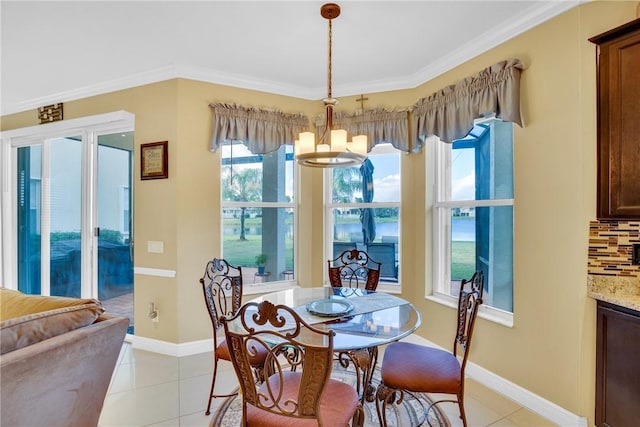 dining area with plenty of natural light, light tile patterned floors, and crown molding