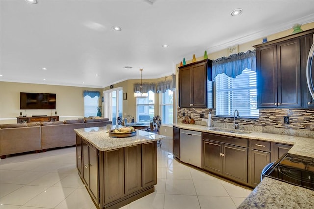 kitchen with light stone counters, crown molding, sink, pendant lighting, and dishwasher