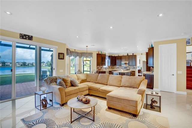 tiled living room with a water view and crown molding