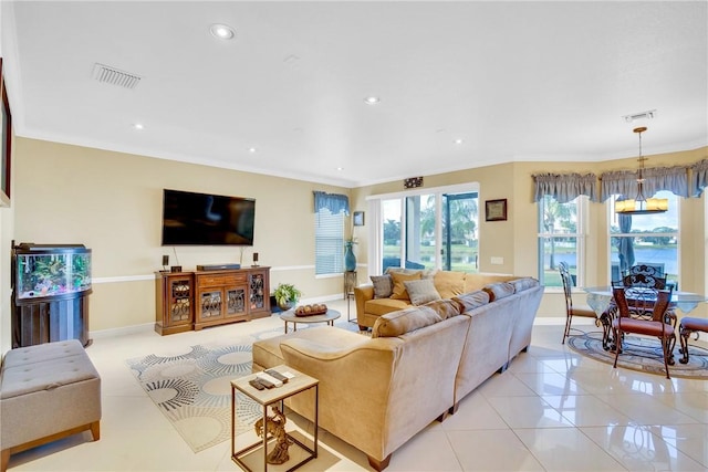 living room featuring crown molding, light tile patterned floors, and a chandelier