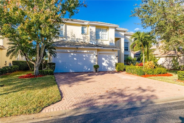 mediterranean / spanish home with a garage and a front yard