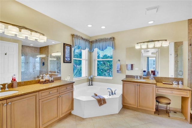 bathroom with tile patterned floors, vanity, and shower with separate bathtub