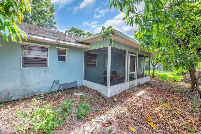 1966 9th St, Vero Beach, FL 32960 - view of property exterior with a sunroom, stucco siding, and roof with shingles