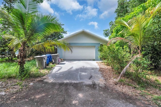 1966 9th St, Vero Beach, FL 32960 - view of side of property featuring driveway and an attached garage