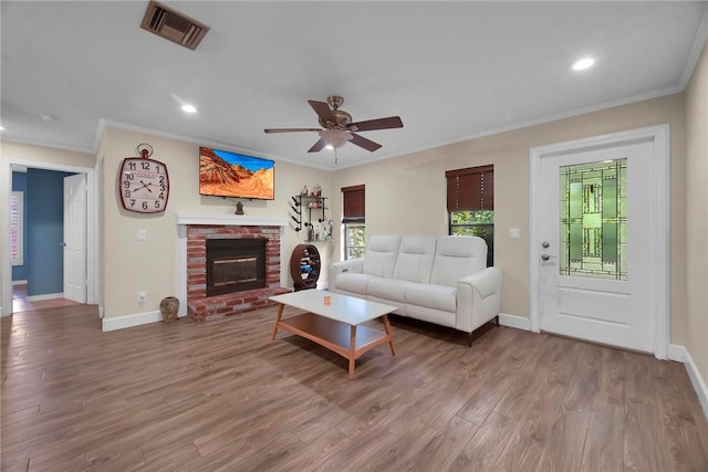 1966 9th St, Vero Beach, FL 32960 - living area with ornamental molding, ceiling fan, recessed lighting, wood finished floors, and a fireplace