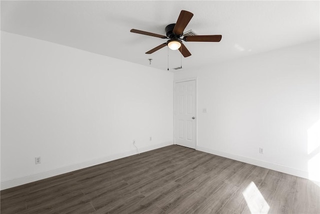 unfurnished room with ceiling fan and dark wood-type flooring