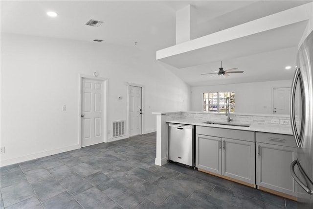 kitchen featuring appliances with stainless steel finishes, tasteful backsplash, sink, ceiling fan, and gray cabinetry