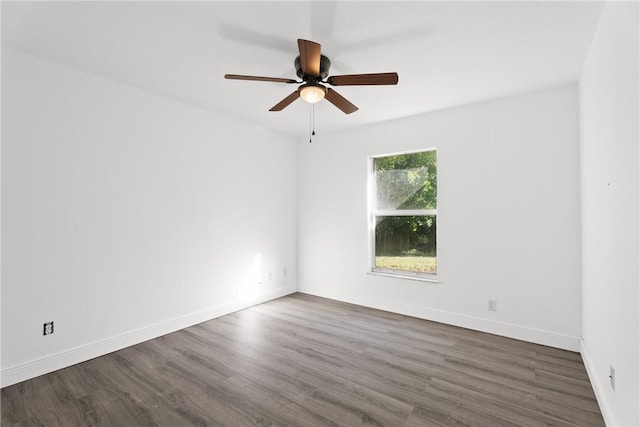 unfurnished room with dark hardwood / wood-style flooring