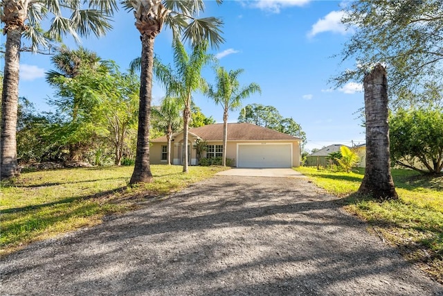 view of front of house with a garage and a front yard