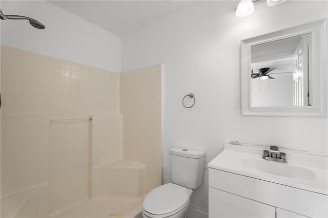 bathroom with walk in shower, vanity, ceiling fan, and toilet