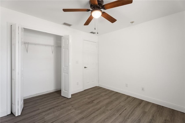 unfurnished bedroom featuring ceiling fan, a closet, and dark hardwood / wood-style floors