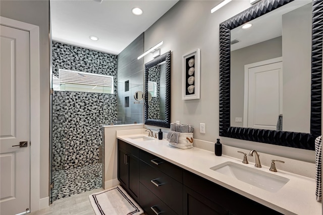 bathroom featuring vanity and tiled shower