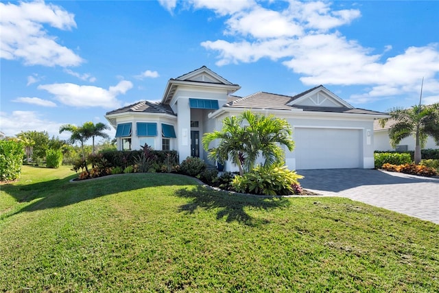 view of front of house featuring a front lawn and a garage