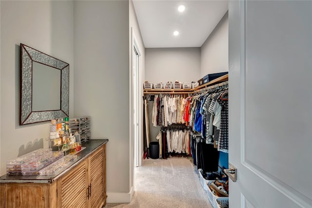 spacious closet featuring light carpet