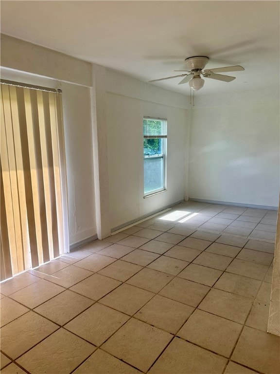 unfurnished room featuring ceiling fan and light tile patterned floors