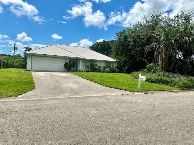 view of front of house featuring a garage and a front yard