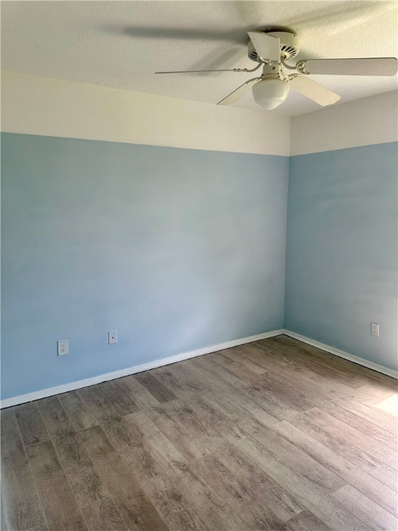 unfurnished room featuring ceiling fan and dark hardwood / wood-style floors