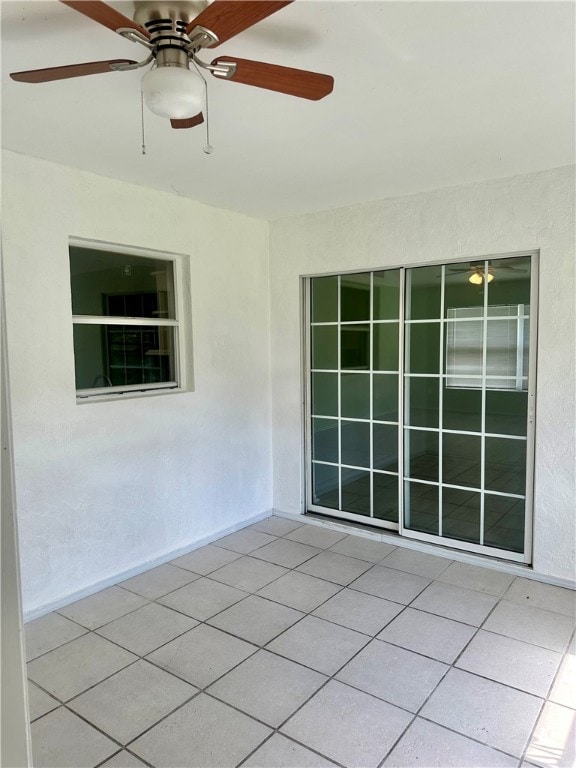 tiled empty room with ceiling fan