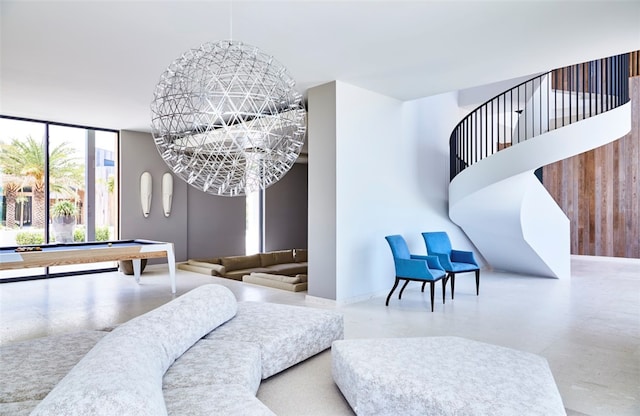 playroom featuring billiards and a notable chandelier