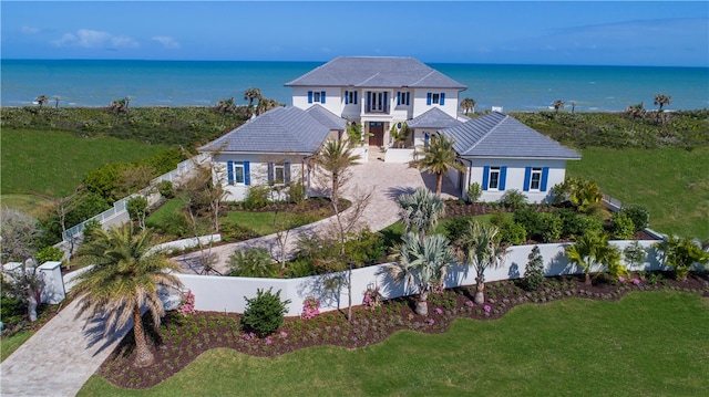 view of front of home with a water view and a front lawn