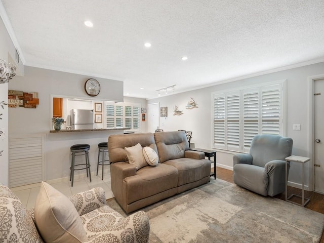 2800 Indian River Blvd Unit J1, Vero Beach, FL 32960 - living room featuring crown molding, recessed lighting, a textured ceiling, and baseboards
