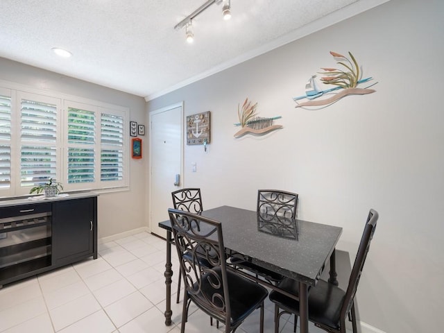 2800 Indian River Blvd Unit J1, Vero Beach, FL 32960 - dining room with a textured ceiling, light tile patterned floors, crown molding, and baseboards