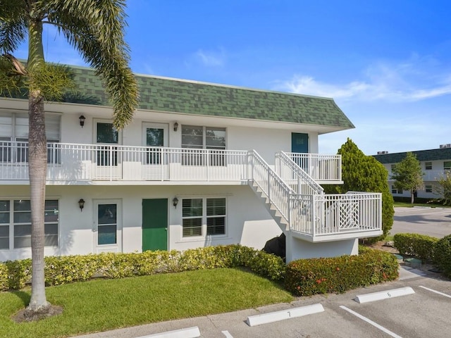 2800 Indian River Blvd Unit J1, Vero Beach, FL 32960 - view of property with uncovered parking and stairs
