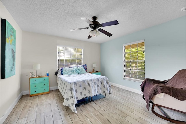 1420 18th Ave SW, Vero Beach, FL 32962 - bedroom featuring light wood-type flooring, baseboards, a textured ceiling, and a ceiling fan