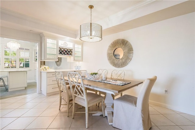 dining space with ornamental molding, baseboards, and light tile patterned floors